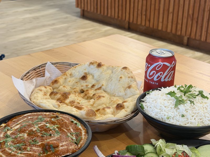 A spread of naan, rice and curries at Mahek